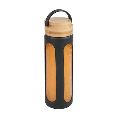 Glass bottle with an orange drink in it